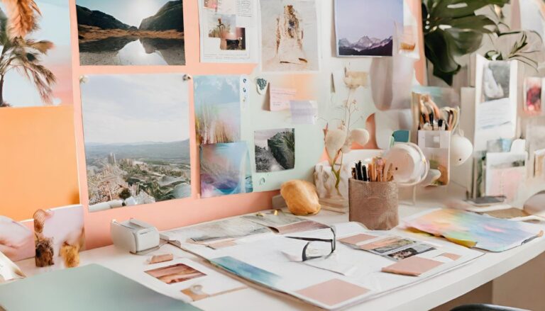 A stylish and well-equipped workspace and a vision board with different colorful scenery photos. Pinterest Affiliate Programs